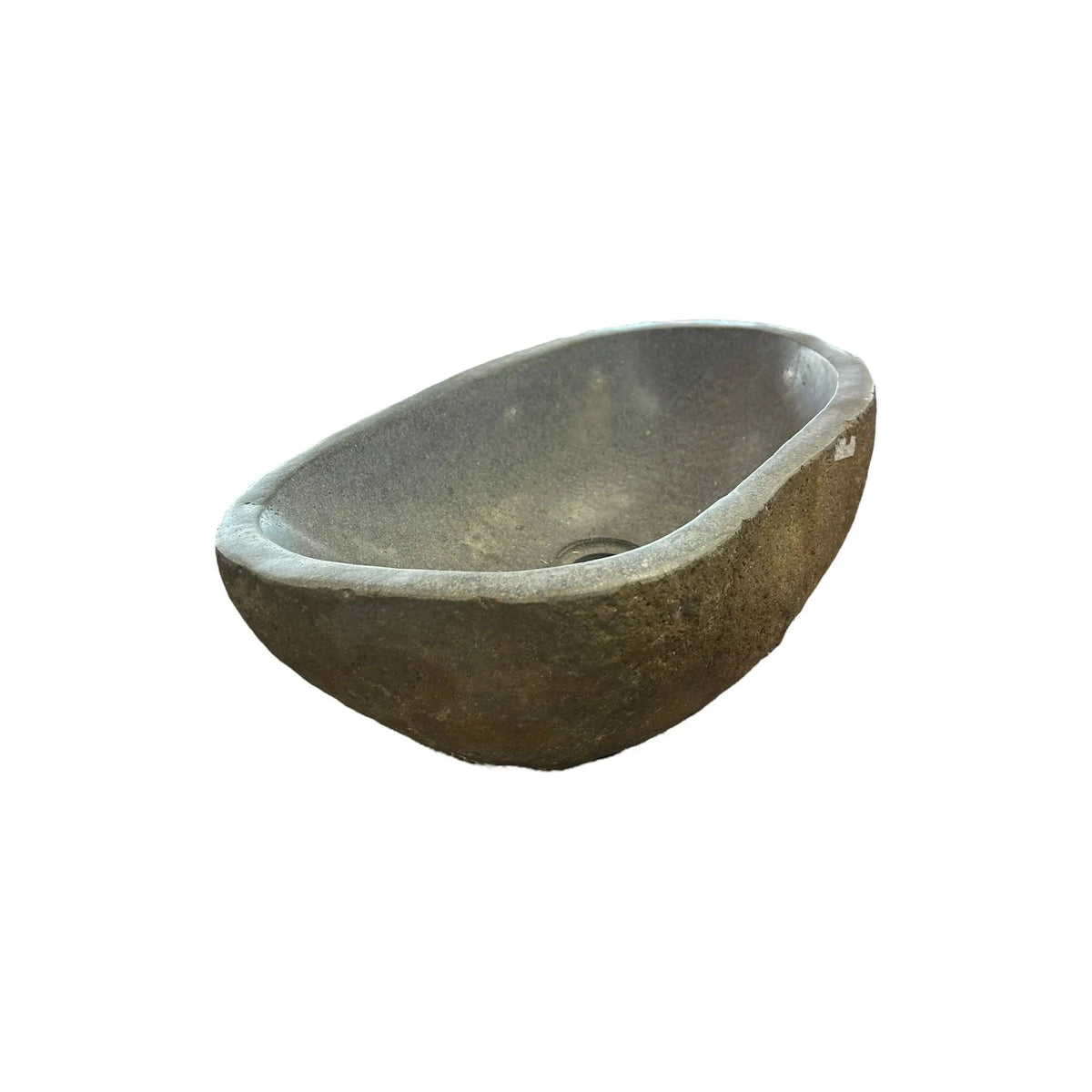 A stone basin sink with a natural finish and muted tones.