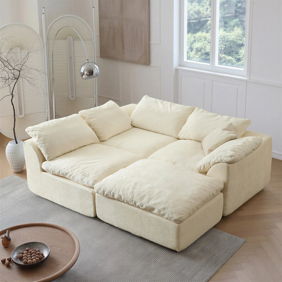 Beige modular sectional sofa in a modern living room with minimalist decor.