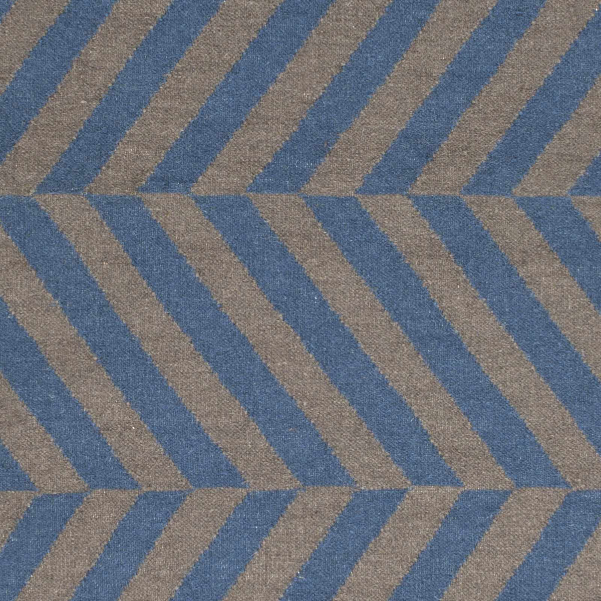 Geometric patterned rug with blue and brown stripes, close-up view.