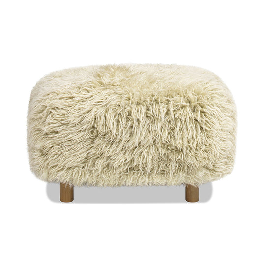 Large rectangular sheepskin footstool with wooden legs, cream colored, on plain background.