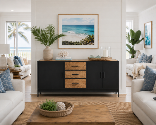 Black sideboard with wooden drawers, coastal decor in a bright living room with a view.