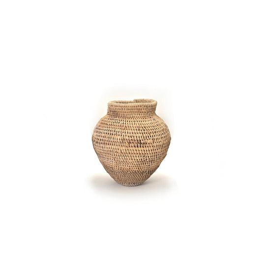 A handwoven, textured basket in beige tones against a white background.
