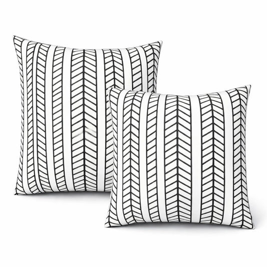 Two black and white patterned outdoor throw pillows on a white background.