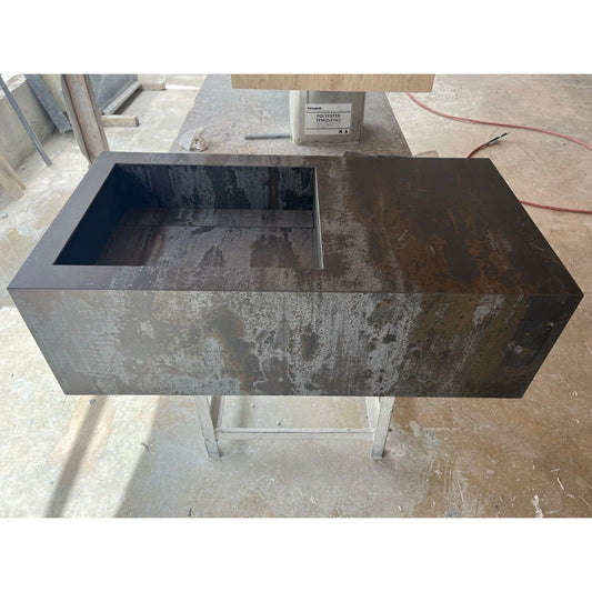 Engineered Porcelain Sink Dekton Trillium Handcrafted Natural Stone on metal stand, grey and brown tones, workshop setting.