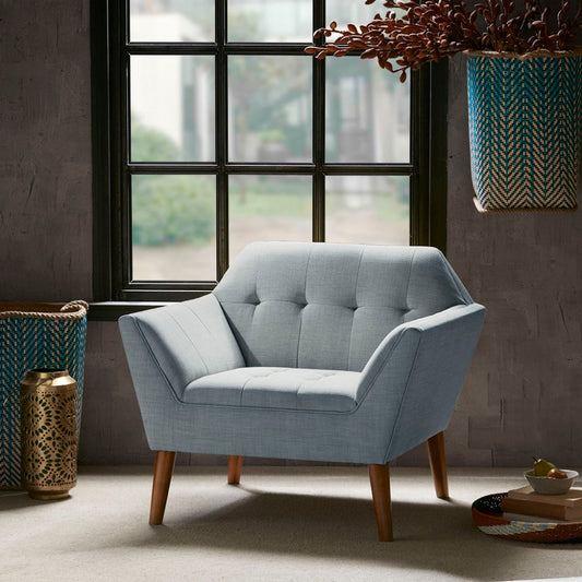Mid-Century Modern lounge chair with button tufting and wooden legs in a chic interior setup