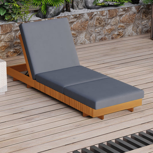 A single chaise lounge with dark cushion on a wooden deck.
