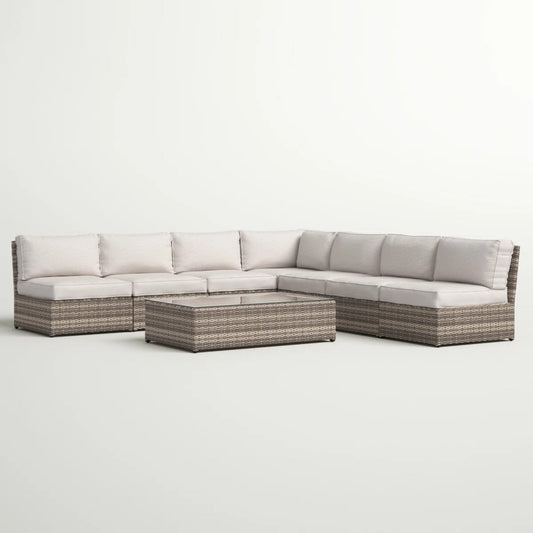 Six-gray-rattan-sectional-with-neutral-cushions-on-a-white-background