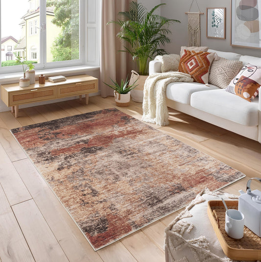 Jewel GC_STU3024 Area Rug, light brown and red abstract design on a wooden floor in a modern living space.