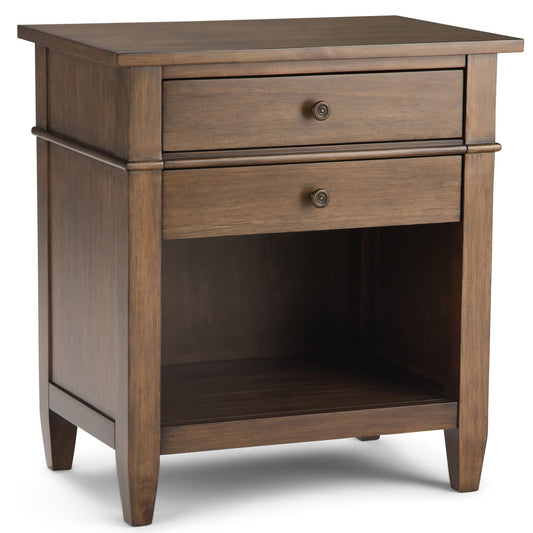 A wooden bedside table with two drawers in a rustic natural aged brown finish, featuring small circular metal knobs and visible grain, placed on a plain white background.