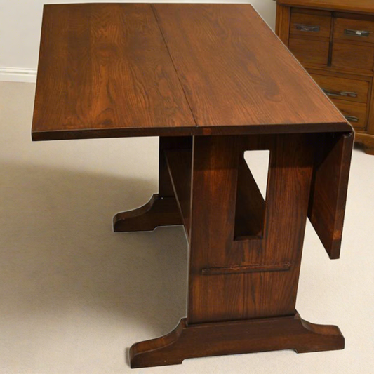 Mission solid oak drop leaf dining table in walnut finish, close-up of top and trestle base