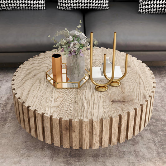 A wooden coffee table with a circular, thin-trimmed design, placed in a modern living room setting. The table has a honeycomb metal holder with decorative items.