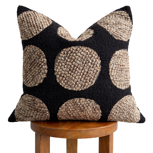 Black and beige textured Samara Pillow Cover on a wooden stool
