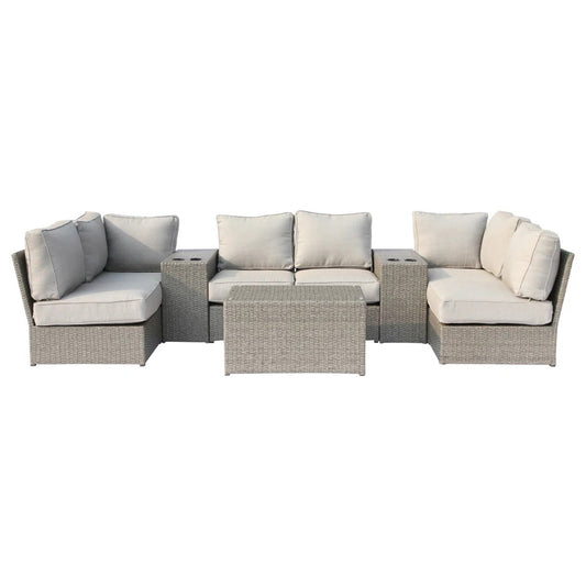 A pre-assembled outdoor wicker seating group for four with white cushions on a plain background.
