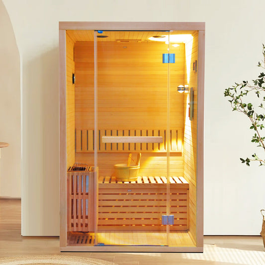 Modern wooden sauna with glass doors, wooden bench, and interior lighting, placed in a bright room with a white wall and wooden floor