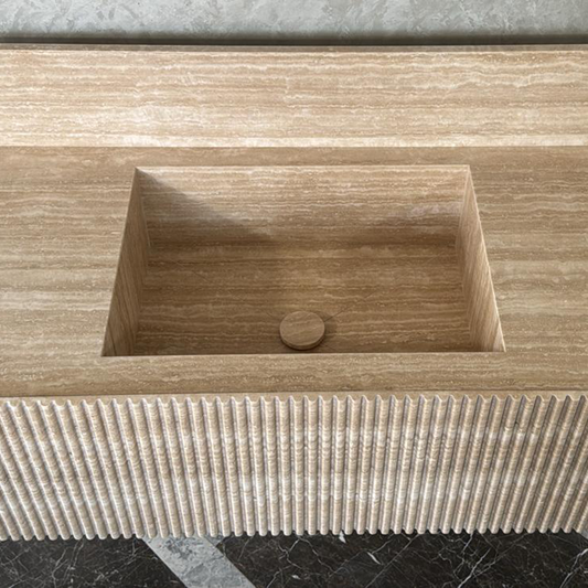 Beige travertine washbasin with vein-cut natural stone, ribbed frame and modern design