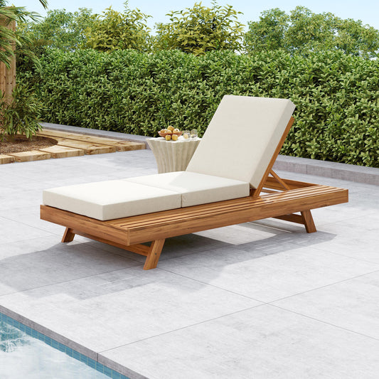 Teak lounge chaise set with cream cushions next to a swimming pool