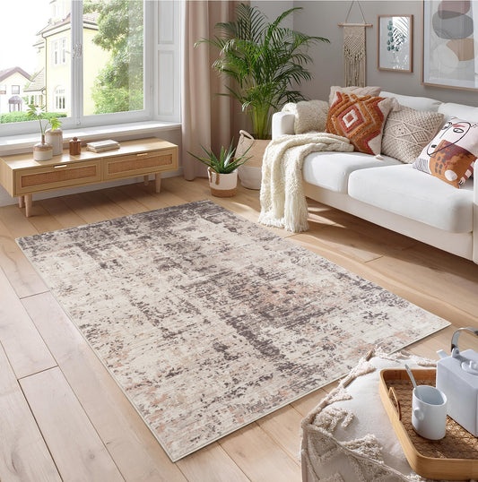A beige and brown patterned area rug on a wooden floor in a modern living room.