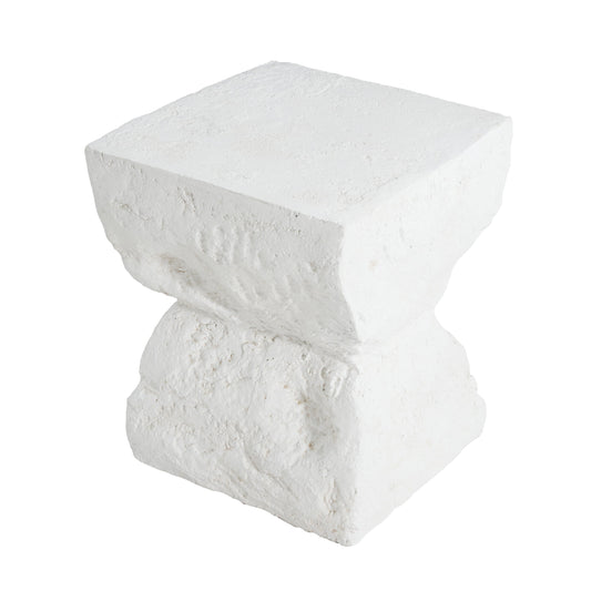 A textured white outdoor table with a cube top and pedestal base, viewed from the side.