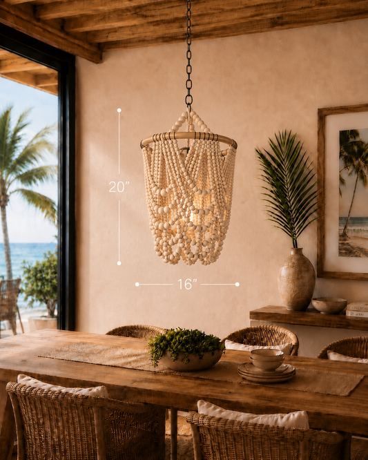 Beachfront dining area with a Nusa Bead Pendant chandelier, wooden elements, earthy tones, and palm tree view.