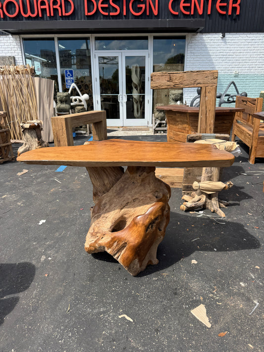 Teak Root Slab Top Bar Table XL (B) on asphalt, natural finish, brown, outside a design center.