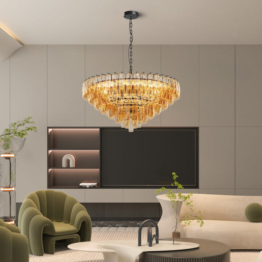 Round smoked glass Tiered Chandelier with a dimmable option, displayed in a modern living room setting with beige walls and green armchair.