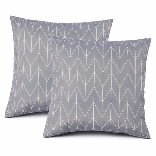 Two light grey throw pillows with subtle triangle pattern