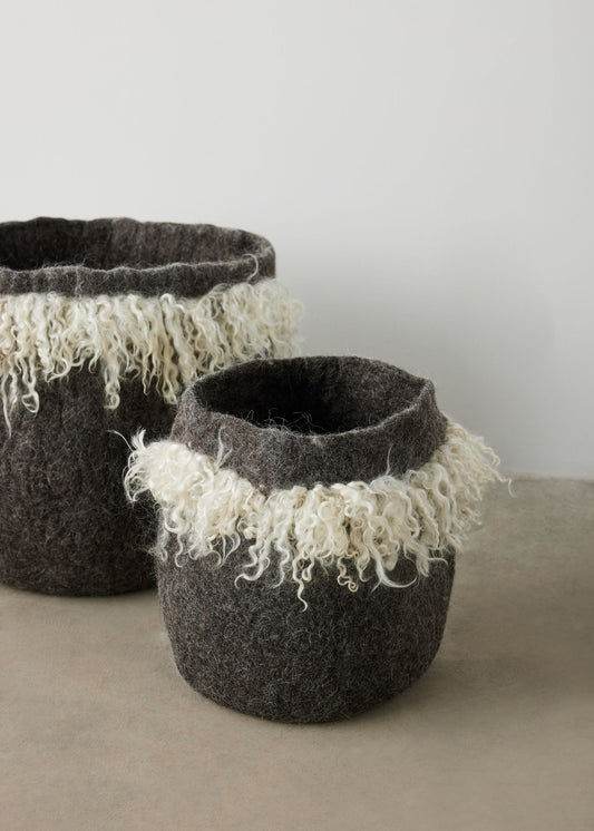Handmade wool baskets with grey skirts and white fringes