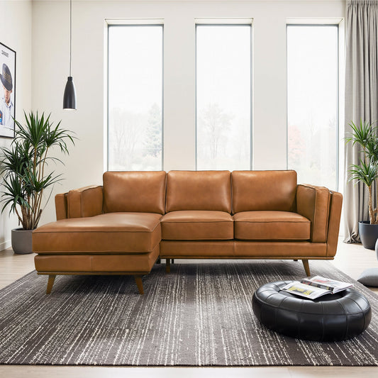 Brown leather sectional couch, modern style, sitting in space with large windows, minimalist decor, light wood floors, and a black pouf, all part of a sophisticated living room setup.