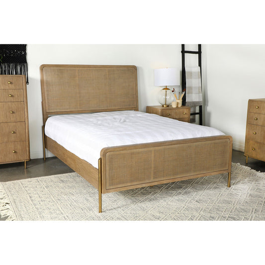 Woven wooden Stevie Bed in natural with brass legs, white matress, beige rug in room setting.