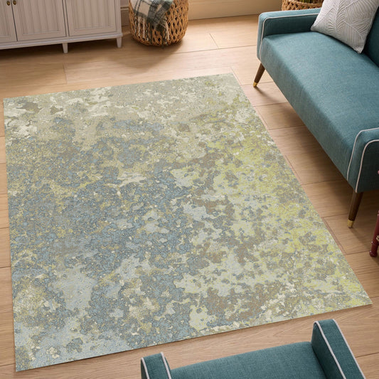 Abstract design rug with a mix of greens, blues, and whites on wooden floor in a living area
