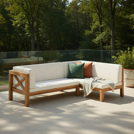 Teak-x-braced corner bench set with cushions and throw pillows on a balcony overlooking greenery.