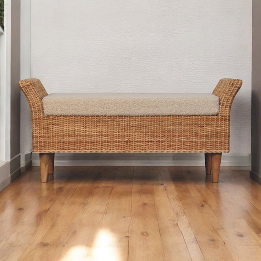 A woven bench with oak legs and cushioned top.