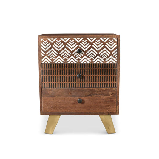 Vintage-style wooden side table with three drawers. Top drawer has a white geometric pattern, middle drawer has black vertical lines, and bottom drawer is solid wood. Gold-painted legs.