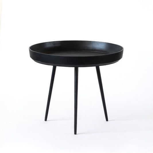 A round black coffee table with three legs, placed on a white background.