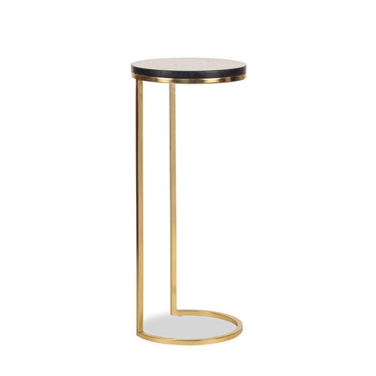 A modern martini table with a black top and gold legs standing against a white background.