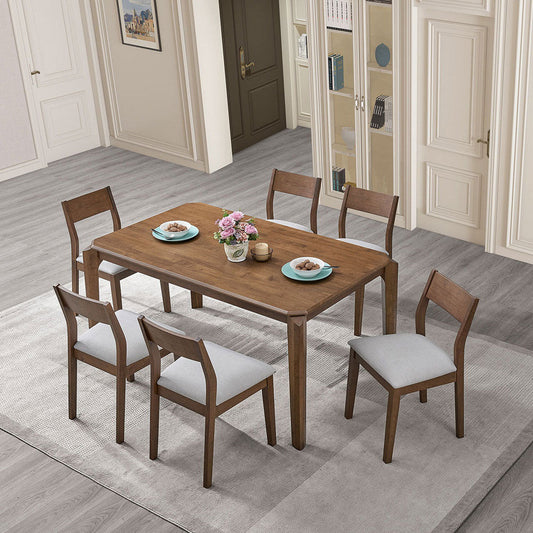 SOLID WOOD DINING TABLE SET with 4 cushioned chairs, white upholstery, on beige carpet in a room with light wood flooring and closed doors in the background.