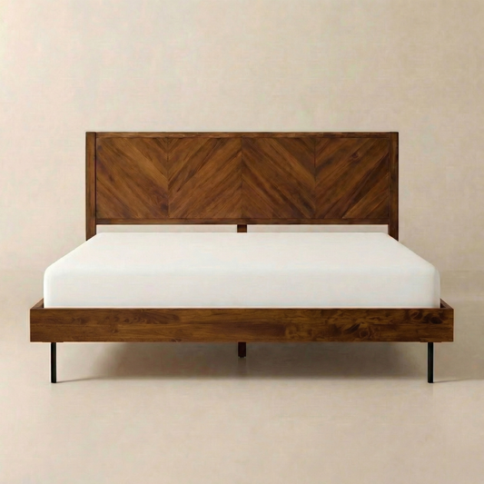 Aged, dark brown wood bed frame with a chevron pattern headboard, mounted on a white mattress.