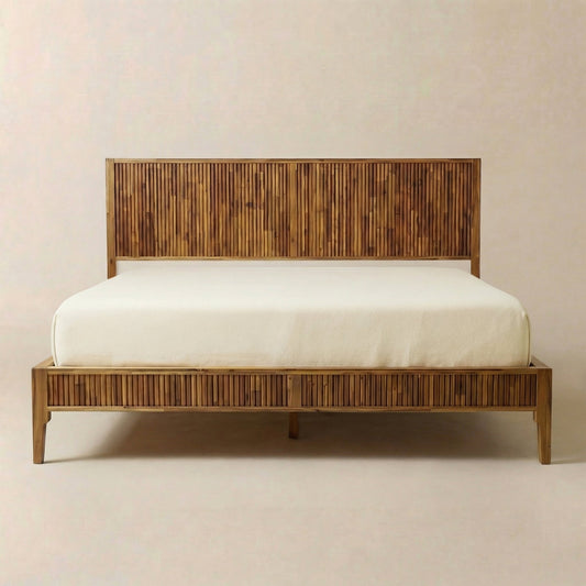 Modern solid wood bed frame with vertical slats, light brown finish, white mattress, against plain background.
