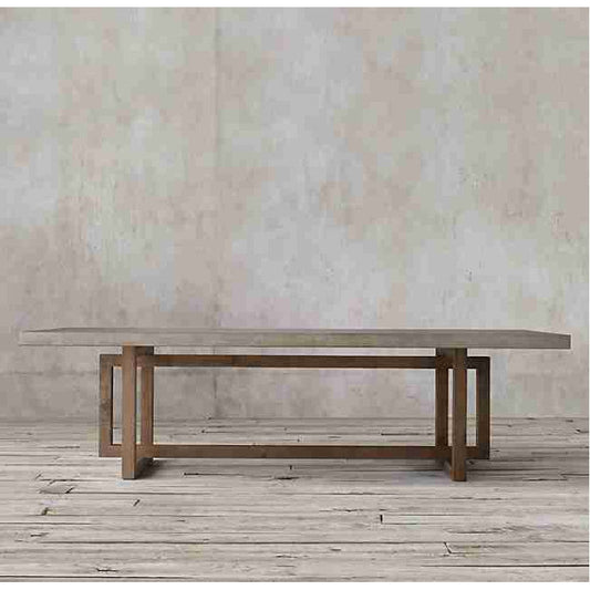 Rectangular lightweight concrete dining table with wooden legs on wooden floor