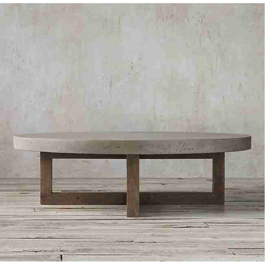 Round concrete coffee table with yellow pine base, 31.5in diameter, placed against textured wall.