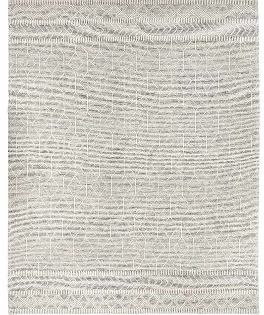 Patterned area rug with geometric design in light neutral tones, neatly laid out.