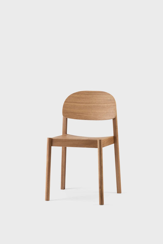 Simple wooden chair with curved back and seat, light brown finish on light background