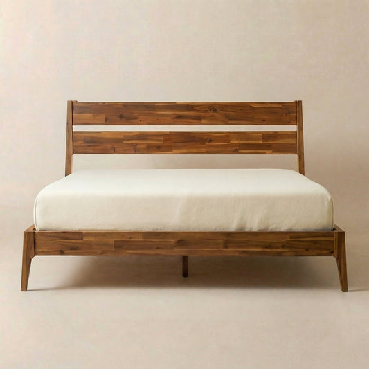 Solid wooden bed frame with a headboard, neatly made mattress in a minimalist setting