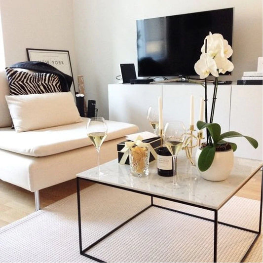 A Carrara White Marble Square Coffee Table Top with Polished Finish in a modern living room setting.