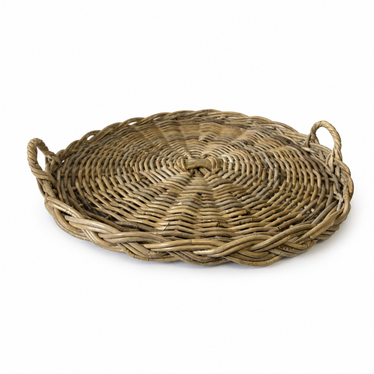 Circular rattan tray with braided pattern and handles, light beige and brown tones.