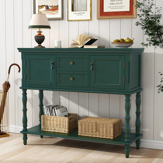 Dark green console table with drawers and shelves, holding baskets and books.