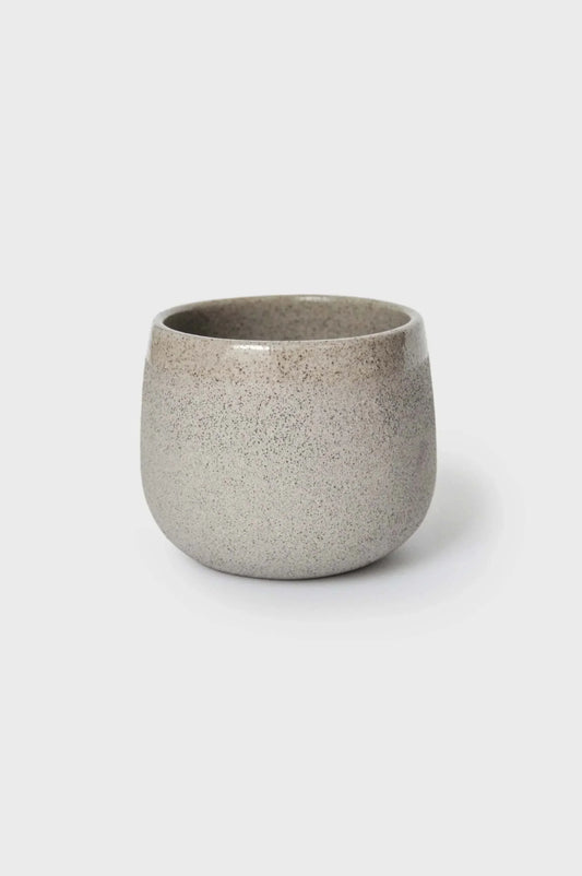 A speckled concrete coffee cup on a white background