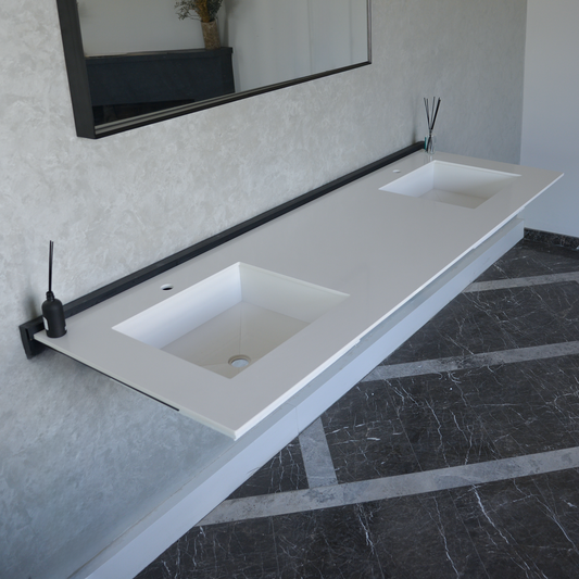 Double sink made of white quartz with smooth edges, supported by a black frame, in a minimalist bathroom with marble floor