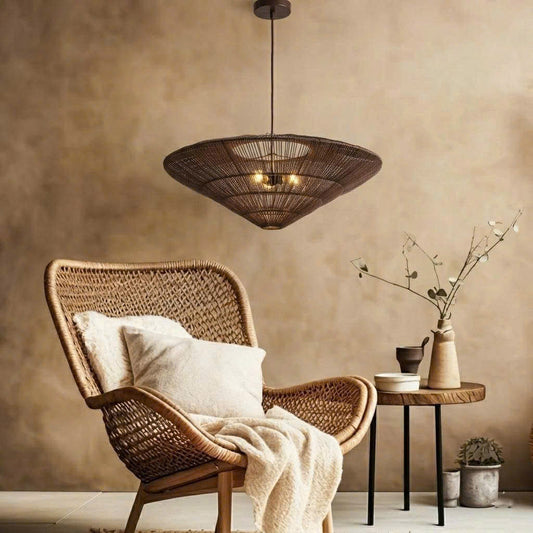 A wide conical rattan pendant light hangs above a wicker chair and small side table with decorative items.