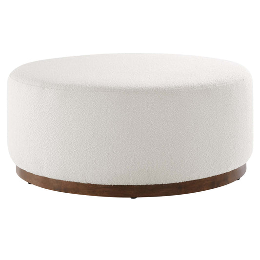 Tilden Large 38" Round Boucle Upholstered Ottoman with a white boucle top and dark wooden base, against a plain background,